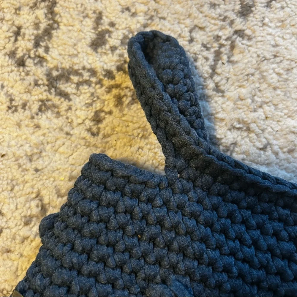 Hand-crocheted blue tote bag with bobble stitch details.